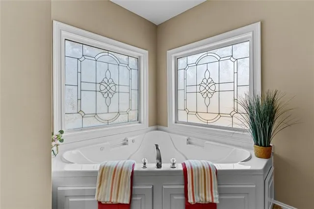 a view of a hallway with wooden floor windows