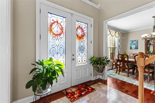 a view of a dining room with furniture and chandelier