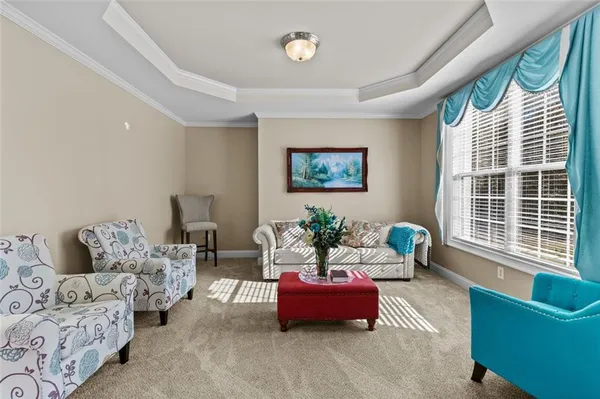 a dining room with furniture a chandelier and wooden floor