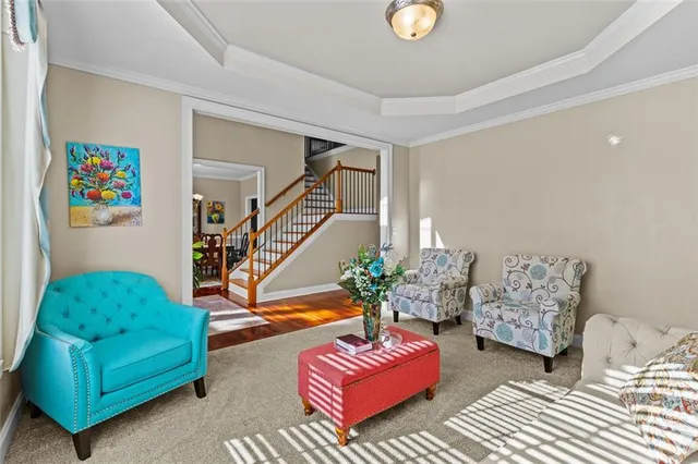 a view of a dining room and livingroom with furniture wooden floor a chandelier