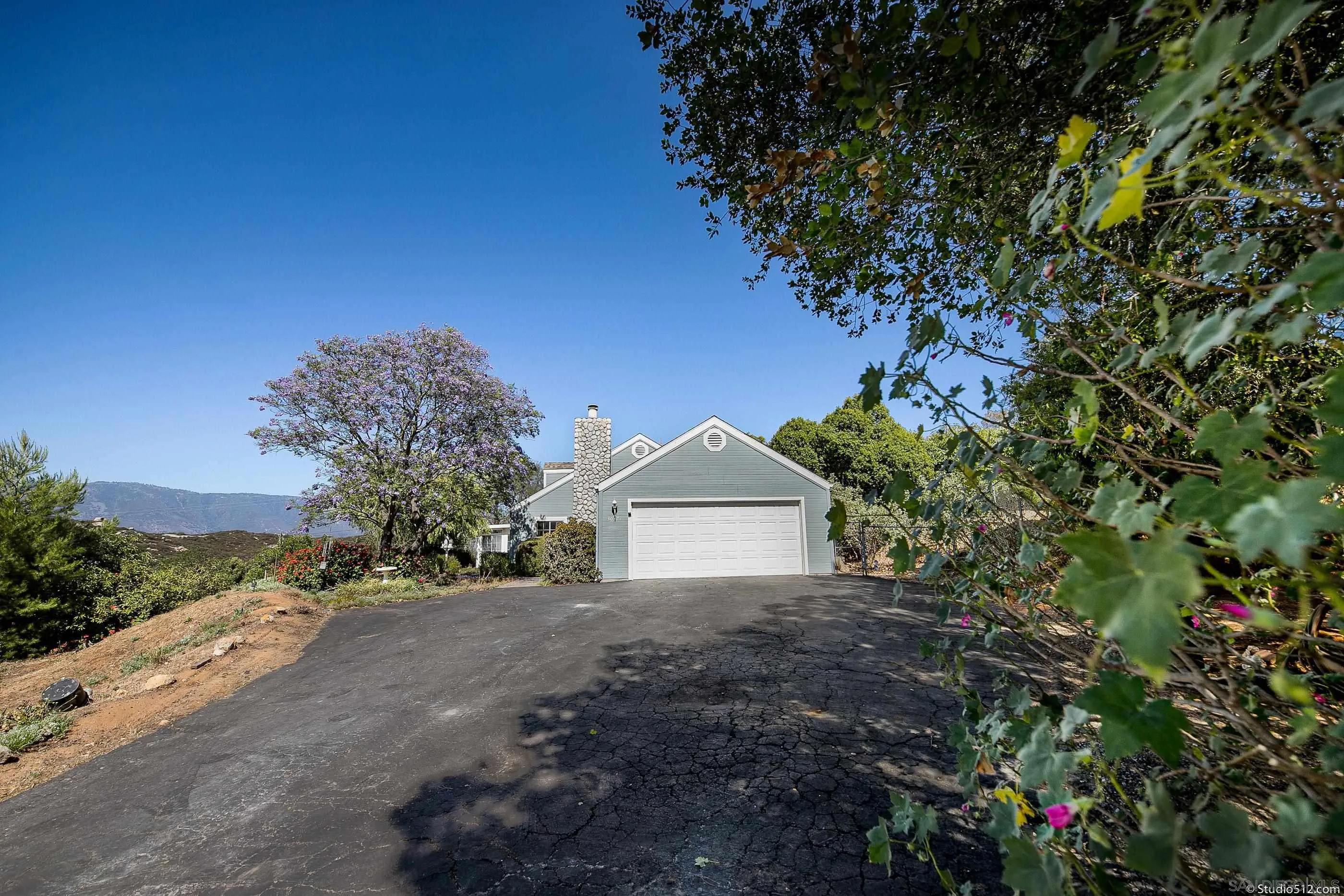 30371 The Yellow Brick Road Valley Center, CA 92082 - Photo 4 of 31 a front view of a house with a garden