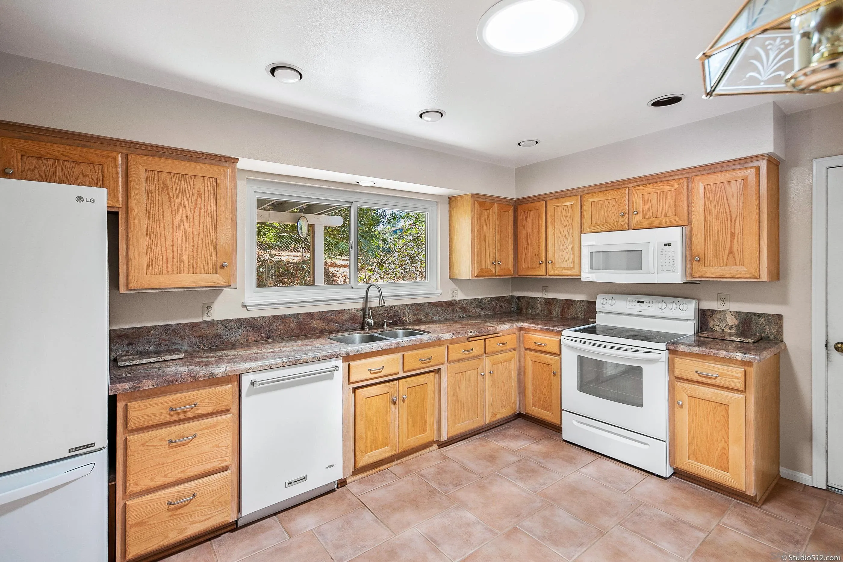 30371 The Yellow Brick Road Valley Center, CA 92082 - Photo 8 of 31 a kitchen with granite countertop white cabinets and white appliances