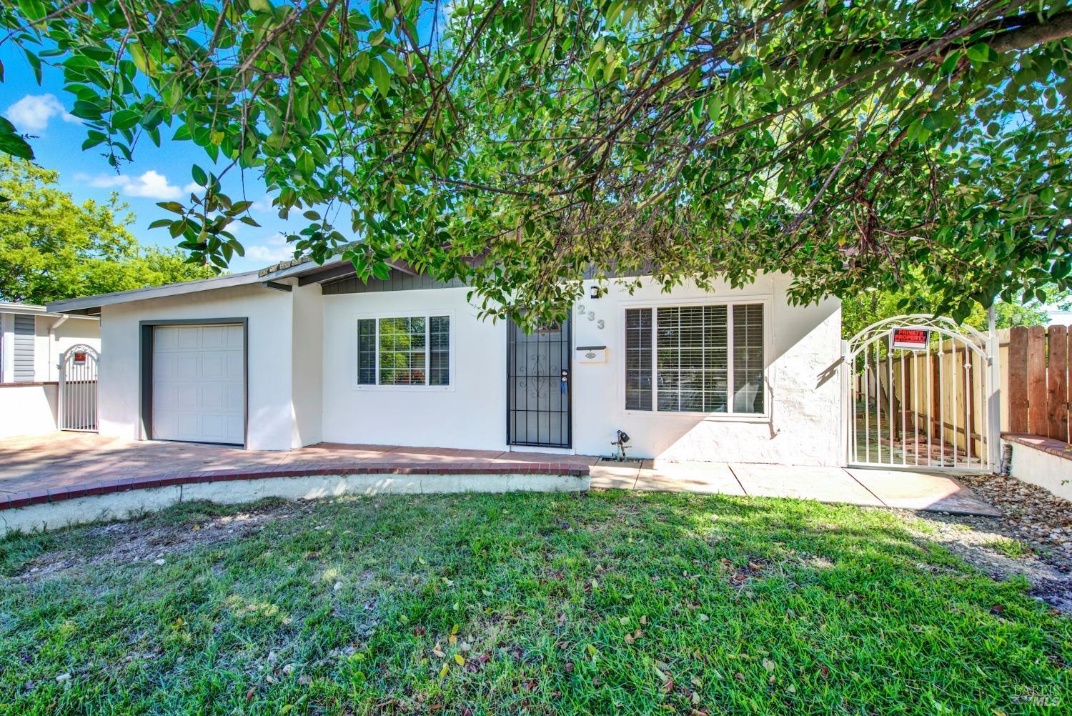 233 Circle Drive Vacaville, CA 95688 - Photo 1 of 1 a front view of a house with a yard and a large tree
