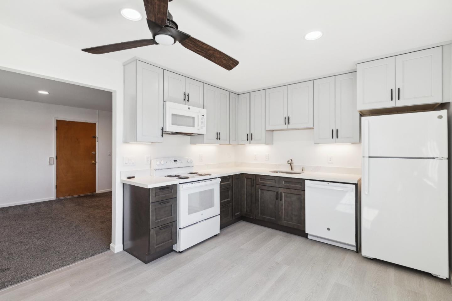 617 Bryan Avenue Sunnyvale, CA 94086 - Photo 6 of 16 a kitchen with stainless steel appliances and white cabinets