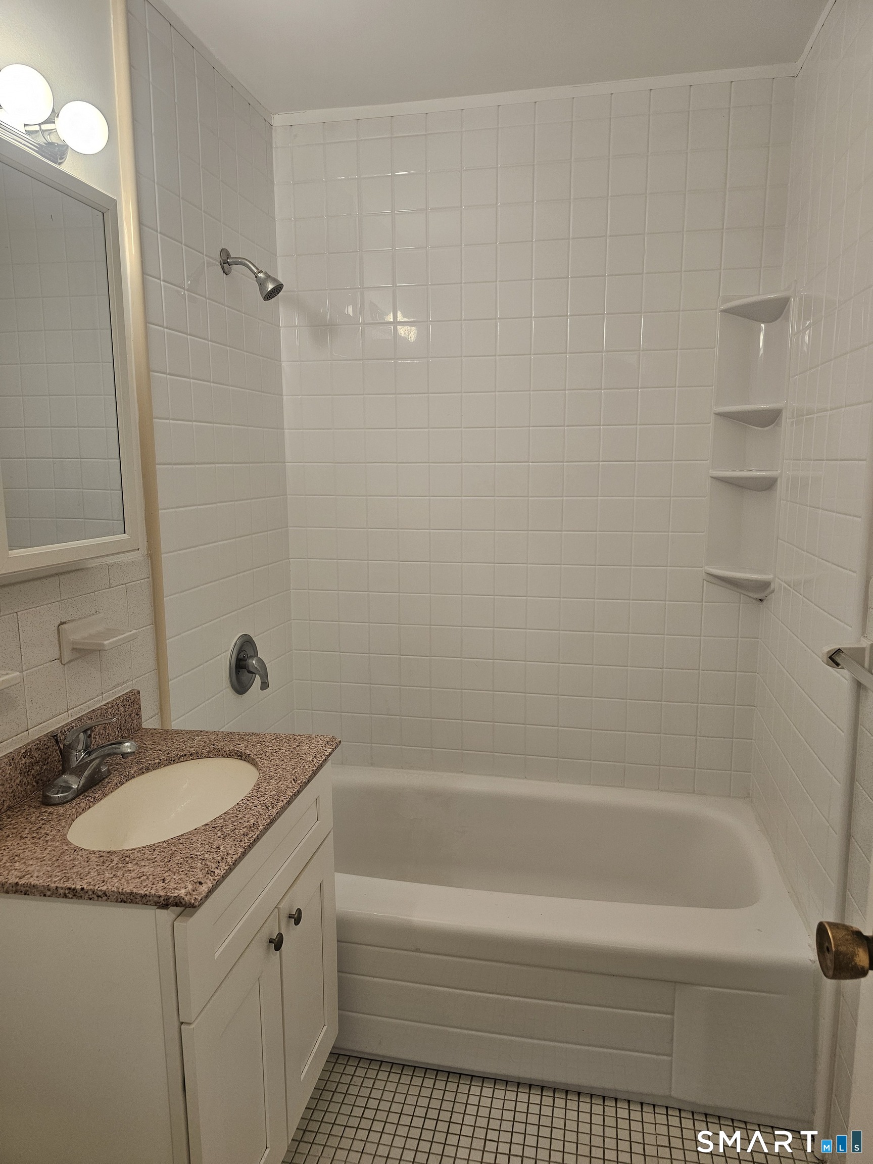 99 Prospect Street, Unit 6I Stamford, CT 06901 - Photo 11 of 11 a bathroom with a granite countertop sink a toilet and shower