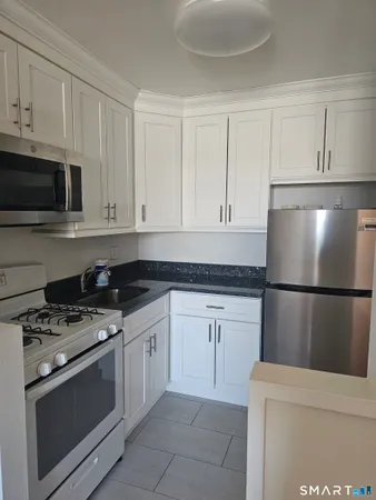 a kitchen with cabinets and steel stainless steel appliances