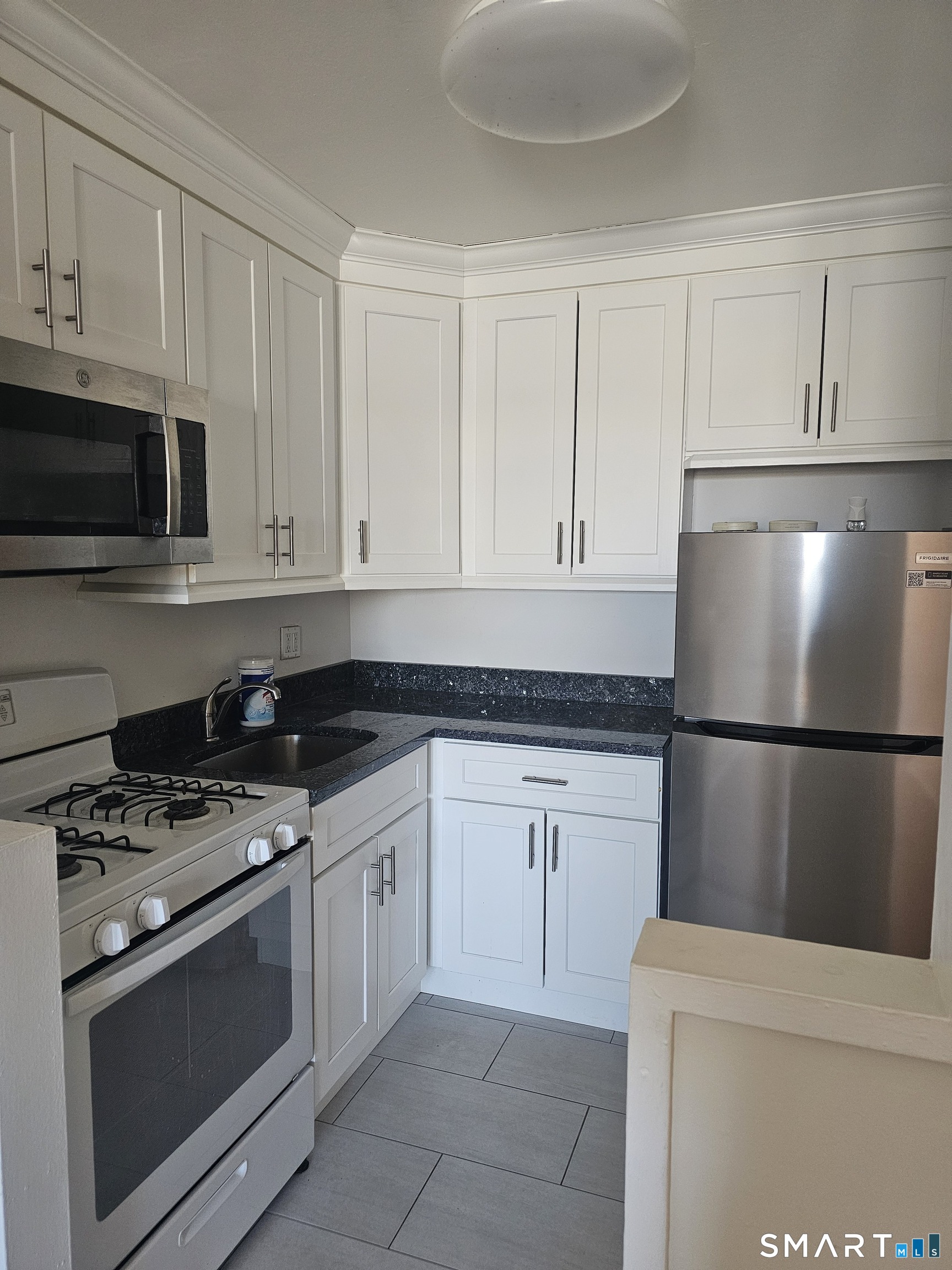 99 Prospect Street, Unit 6I Stamford, CT 06901 - Photo 6 of 11 a kitchen with cabinets and steel stainless steel appliances