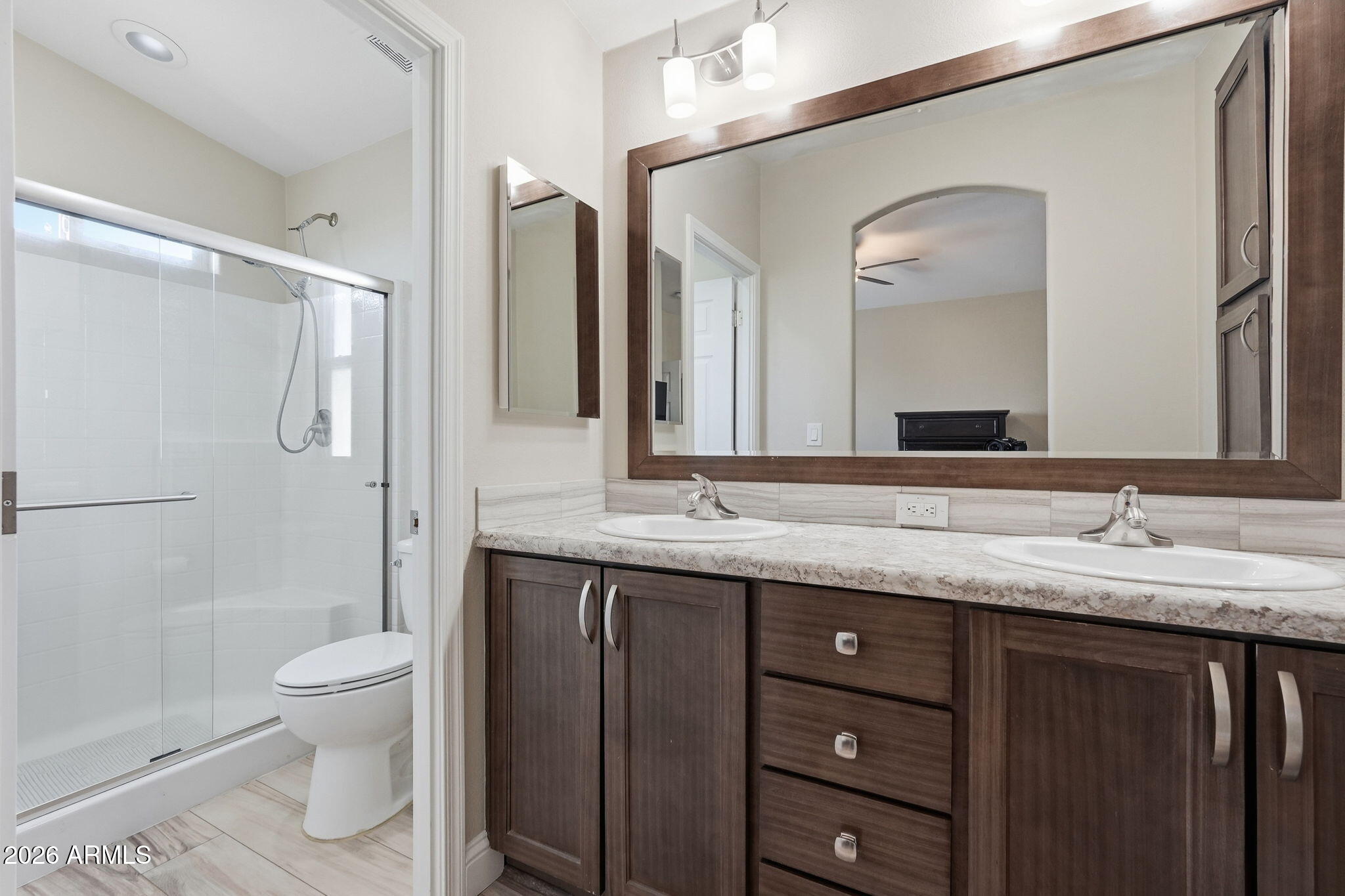 8865 East Baseline Road, Unit 1417 Mesa, AZ 85209 - Photo 20 of 47 a bathroom with a granite countertop sink toilet and shower