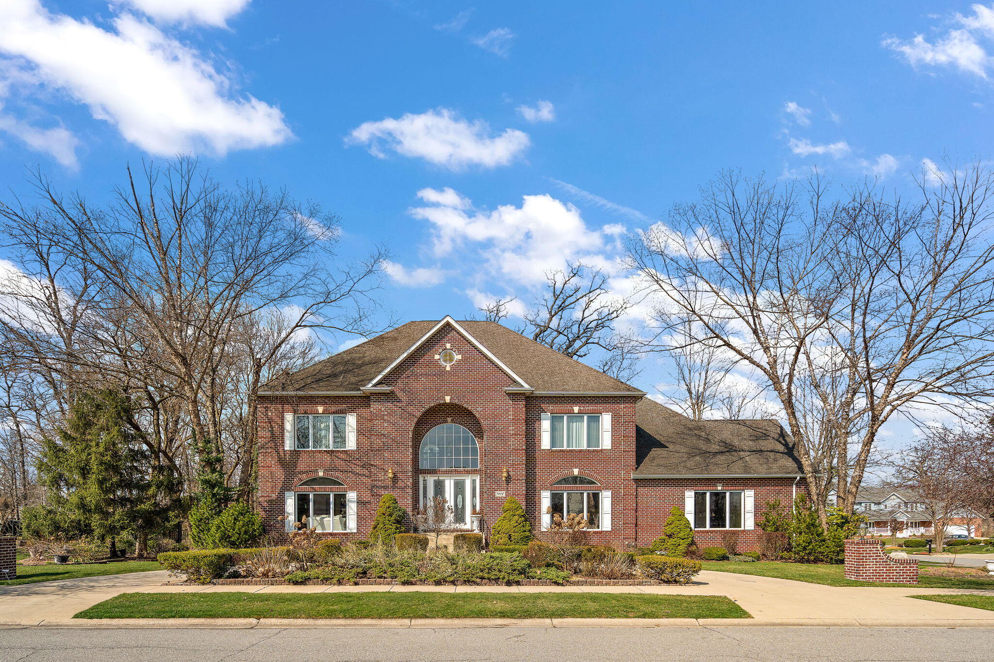 7412 Forest Ridge Drive Schererville, IN 46375 - Photo 2 of 60 a front view of a house with a yard