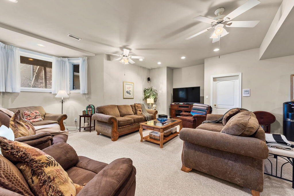 7412 Forest Ridge Drive Schererville, IN 46375 - Photo 44 of 60 a living room with furniture and a flat screen tv