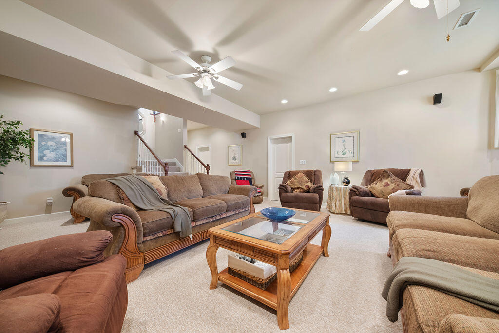 7412 Forest Ridge Drive Schererville, IN 46375 - Photo 46 of 63 a living room with furniture a ceiling fan and a rug