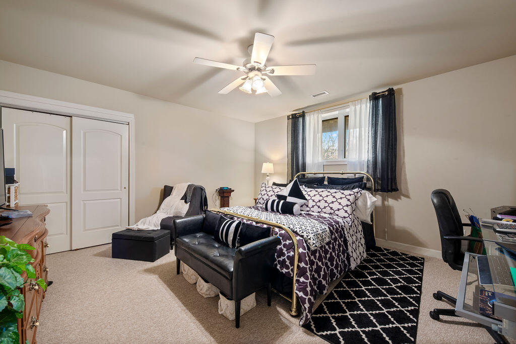 7412 Forest Ridge Drive Schererville, IN 46375 - Photo 47 of 60 a bedroom with a bed a couch and potted plant