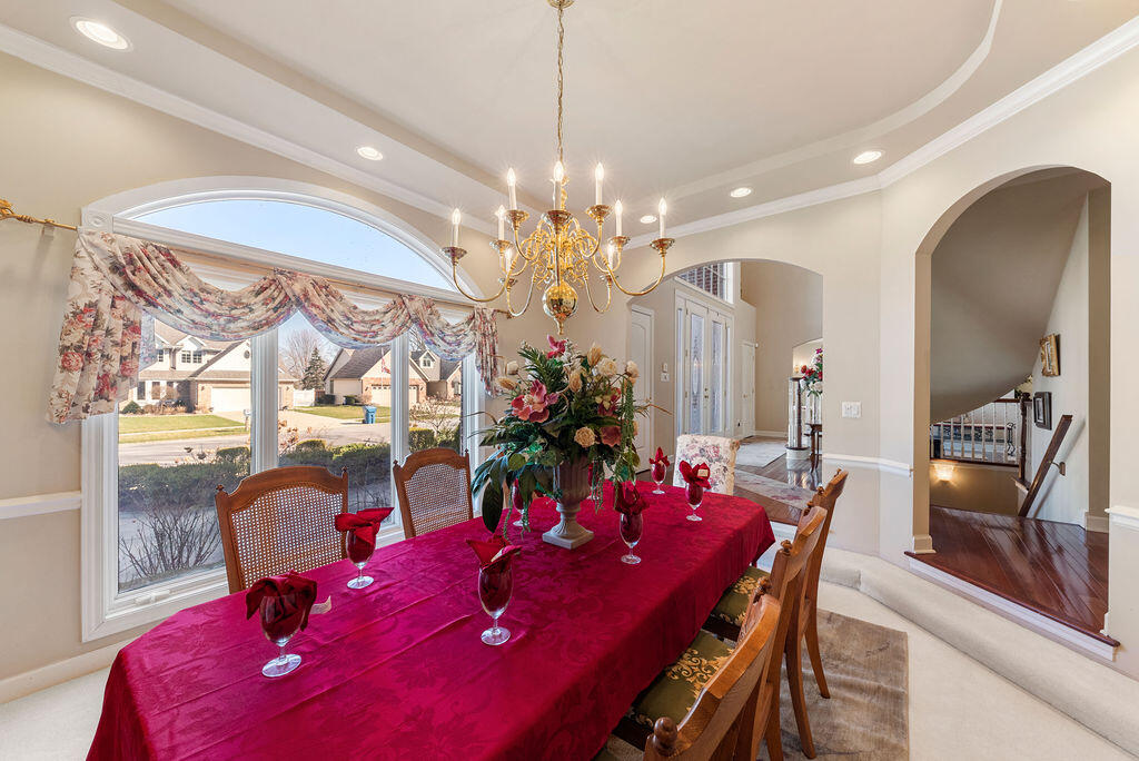 7412 Forest Ridge Drive Schererville, IN 46375 - Photo 10 of 60 a view of a dining room with furniture and chandelier