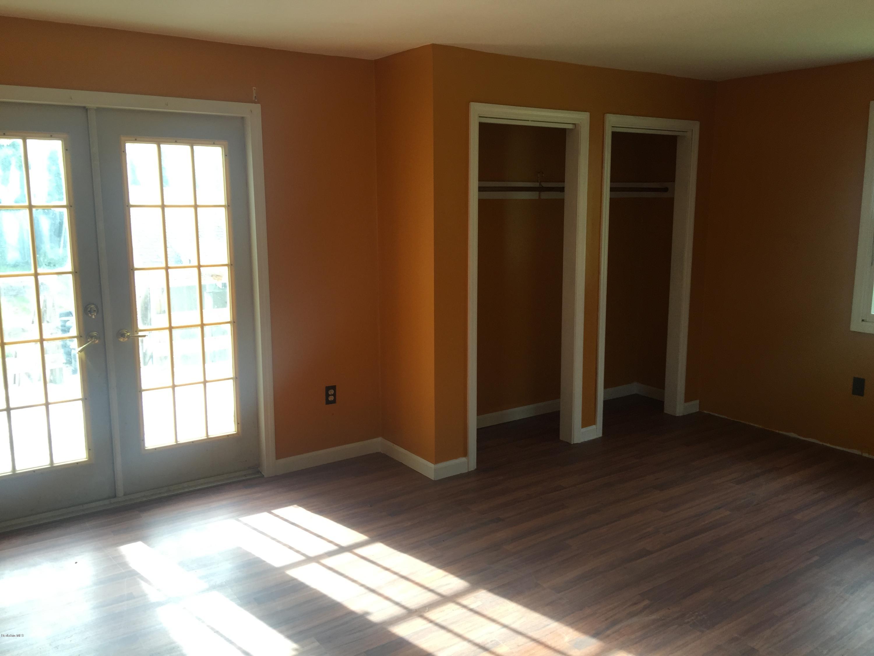 386 South Washington State Road Washington, MA 01223 - Photo 9 of 15 an empty room with wooden floor and windows