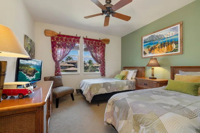 a bedroom with two beds and a painting on the wall