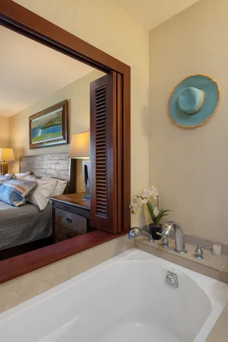 a spacious bathroom with a granite countertop sink and a mirror