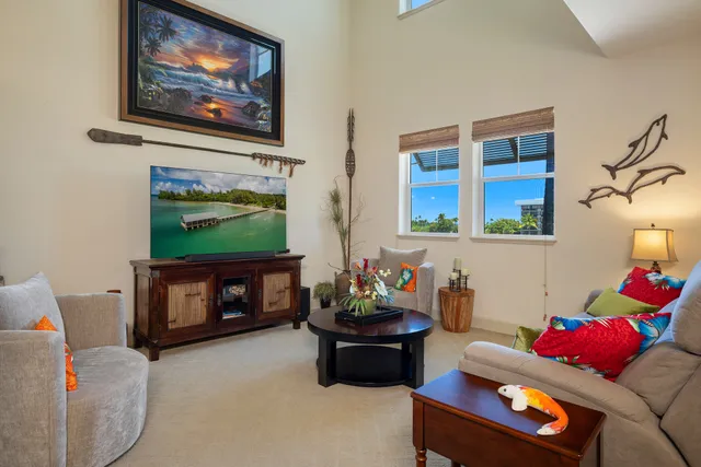 a living room with furniture a flat screen tv and a fireplace