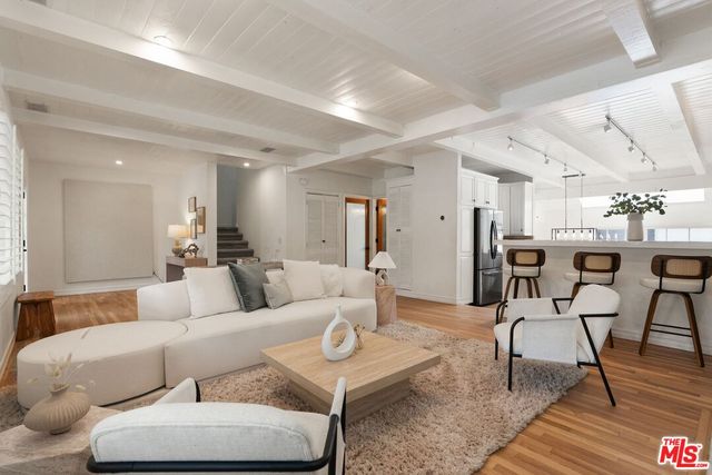 a living room with furniture and kitchen view