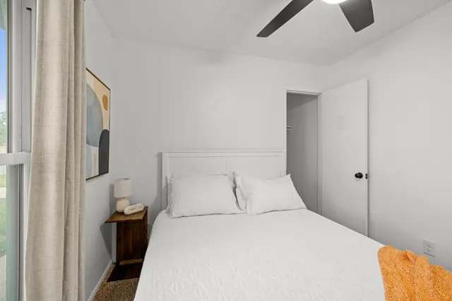 a bedroom with a bed and cabinets