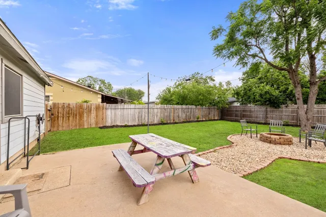 a view of a garden with furniture
