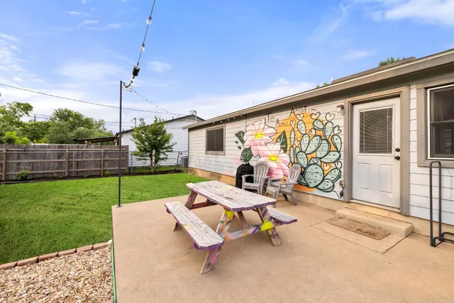 a view of a patio with a table chairs and a yard