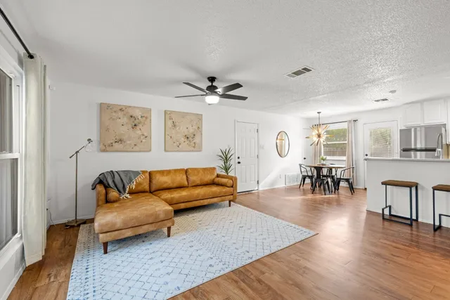 a living room with furniture and wooden floor