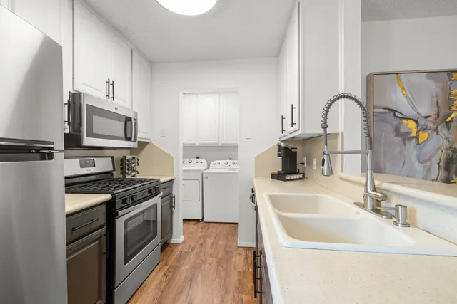 a kitchen with a sink stove and refrigerator