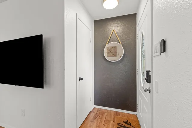 a view of a hallway with wooden floor