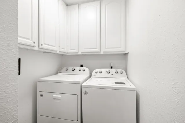 a view of storage and utility room with washer and dryer