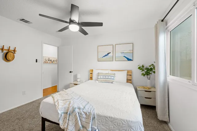 a bedroom with a bed and a chandelier