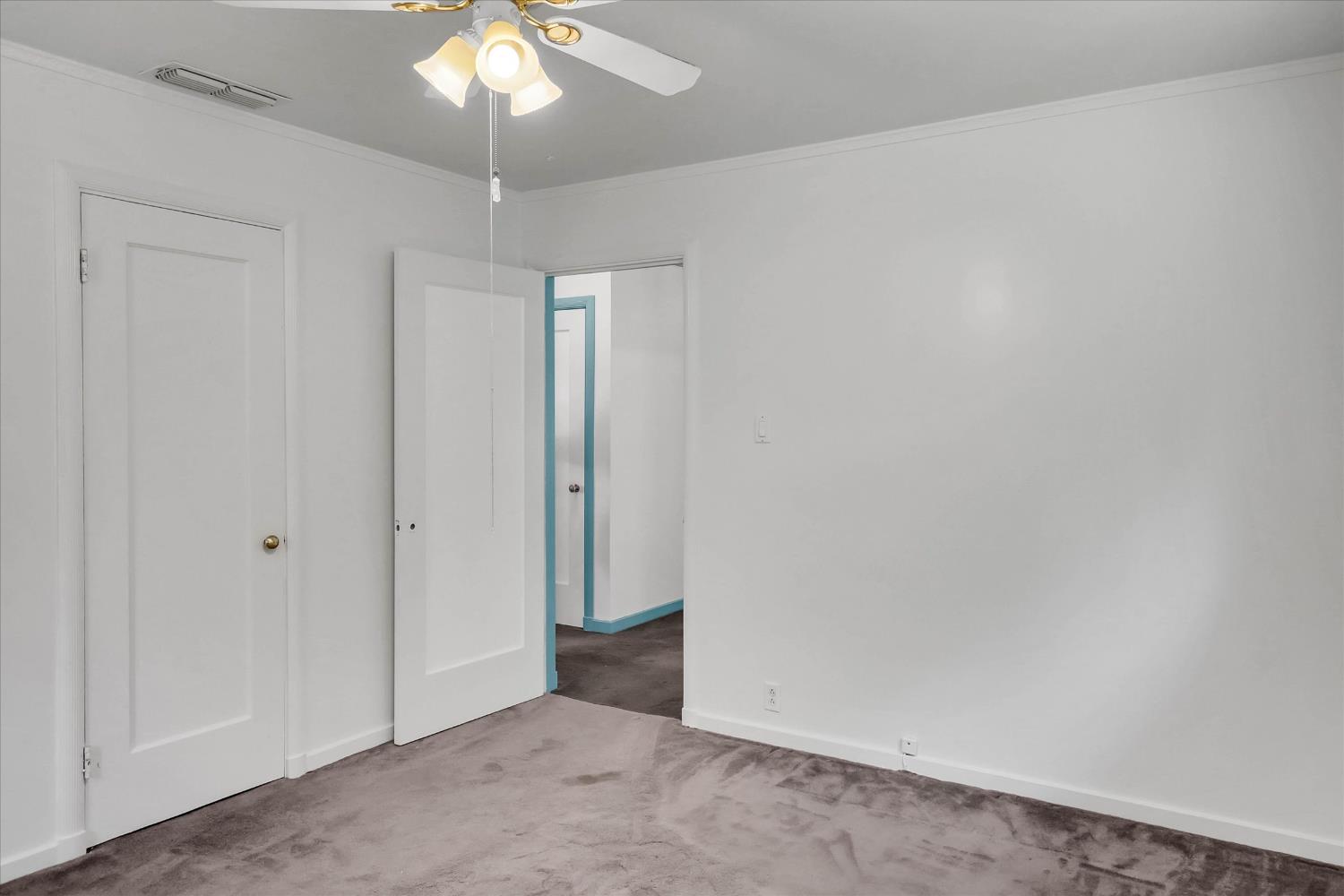 39640 South River Road Clarksburg, CA 95612 - Photo 17 of 25 an empty room with a chandelier fan and closet area