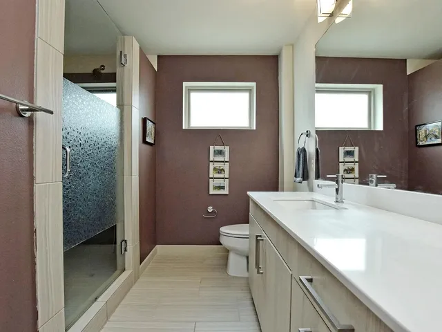 a kitchen with stainless steel appliances kitchen island granite countertop a stove a sink a oven a dining table and chairs with wooden floor