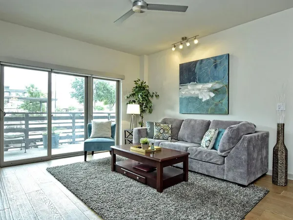 a living room with furniture and a large rug