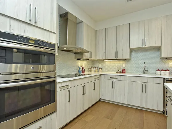 a kitchen with granite countertop white cabinets and white appliances
