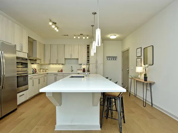 a large room with stainless steel appliances lots of counter space and breakfast area