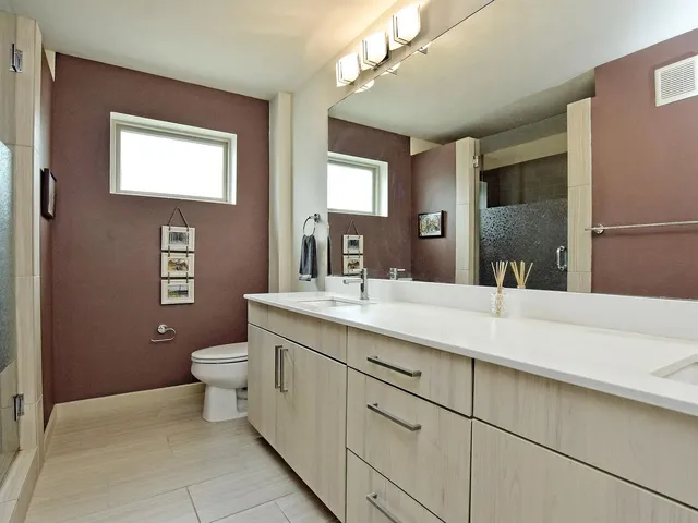 a bedroom with a bed and large window