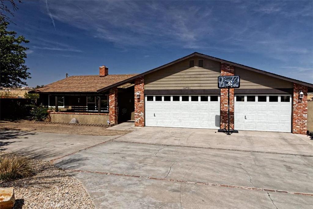 14791 Nokomis Road Apple Valley, CA 92307 - Photo 1 of 1 a front view of a house with a garage