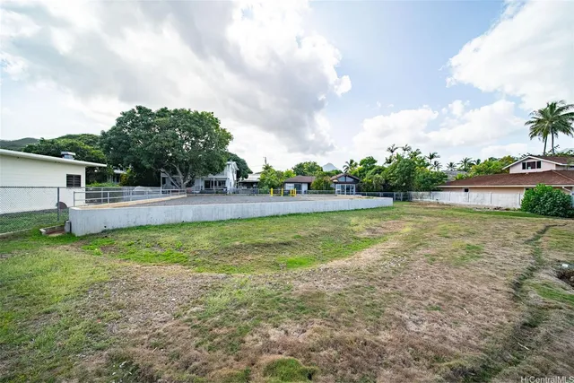 a view of a house with a yard and sitting area