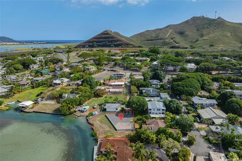 an aerial view of residential houses with outdoor space and trees