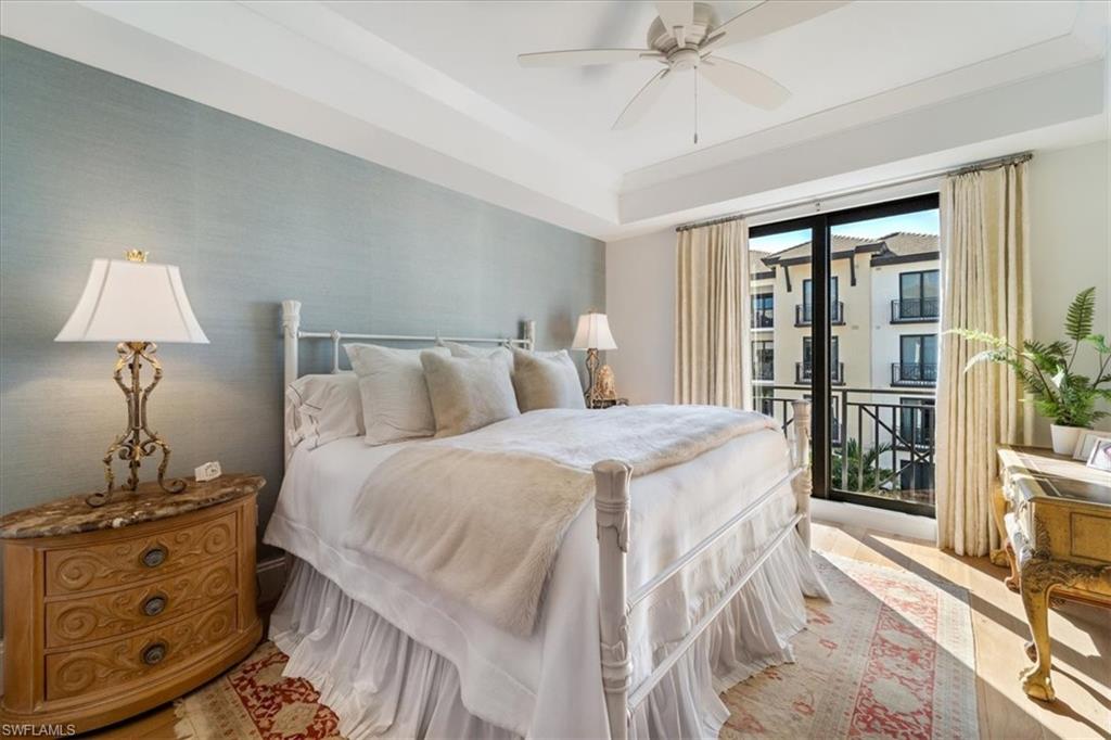 1135 3rd Avenue South, Unit 409 Naples, FL 34102 - Photo 19 of 44 a bedroom with a bed and a chandelier