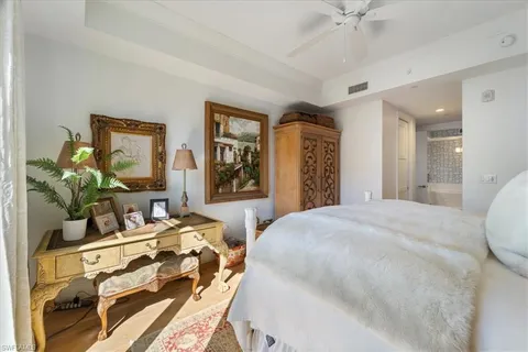 a bedroom with a bed table and dresser