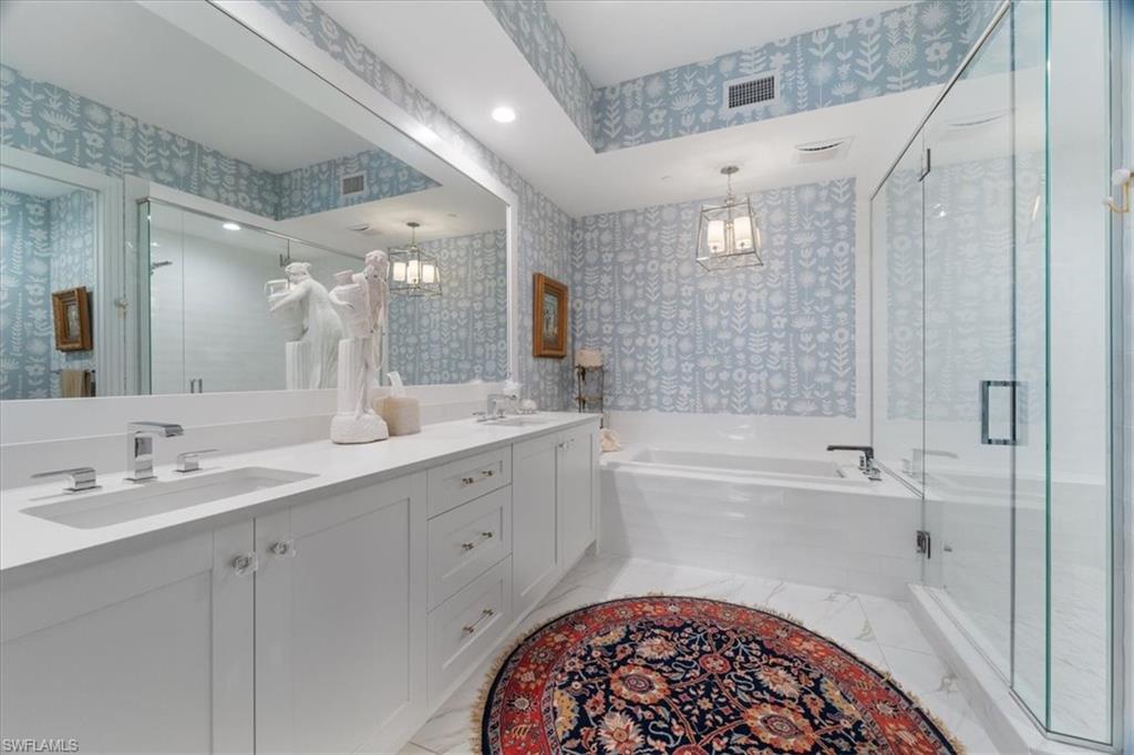 1135 3rd Avenue South, Unit 409 Naples, FL 34102 - Photo 22 of 44 a spacious bathroom with a sink a mirror a bathtub and shower