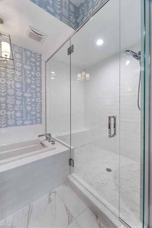 1135 3rd Avenue South, Unit 409 Naples, FL 34102 - Photo 25 of 44 a bathroom with a bathtub and a shower