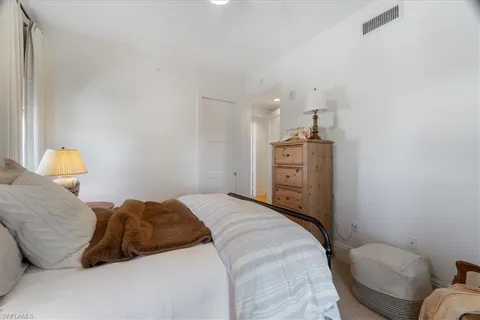 a bedroom with a bed and dresser