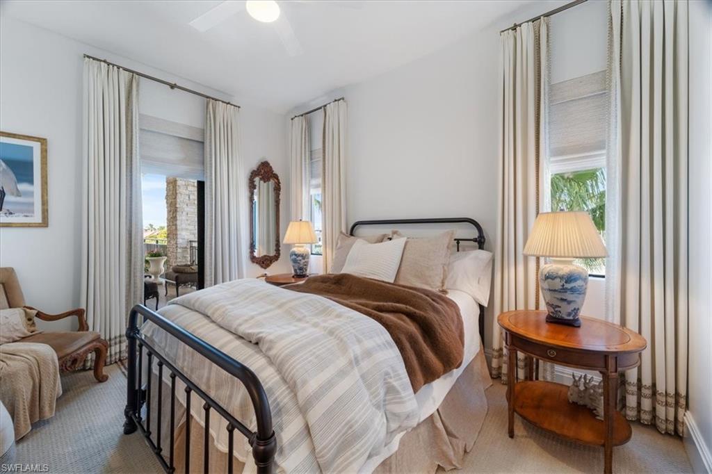 1135 3rd Avenue South, Unit 409 Naples, FL 34102 - Photo 29 of 44 a bedroom with a bed and a mirror