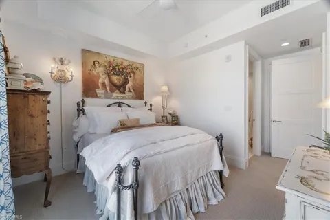 a bedroom with a bed and a painting on the wall