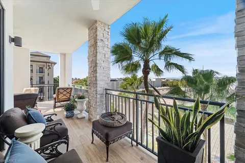 a view of a balcony with furniture