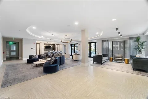 a living room with furniture and view of kitchen