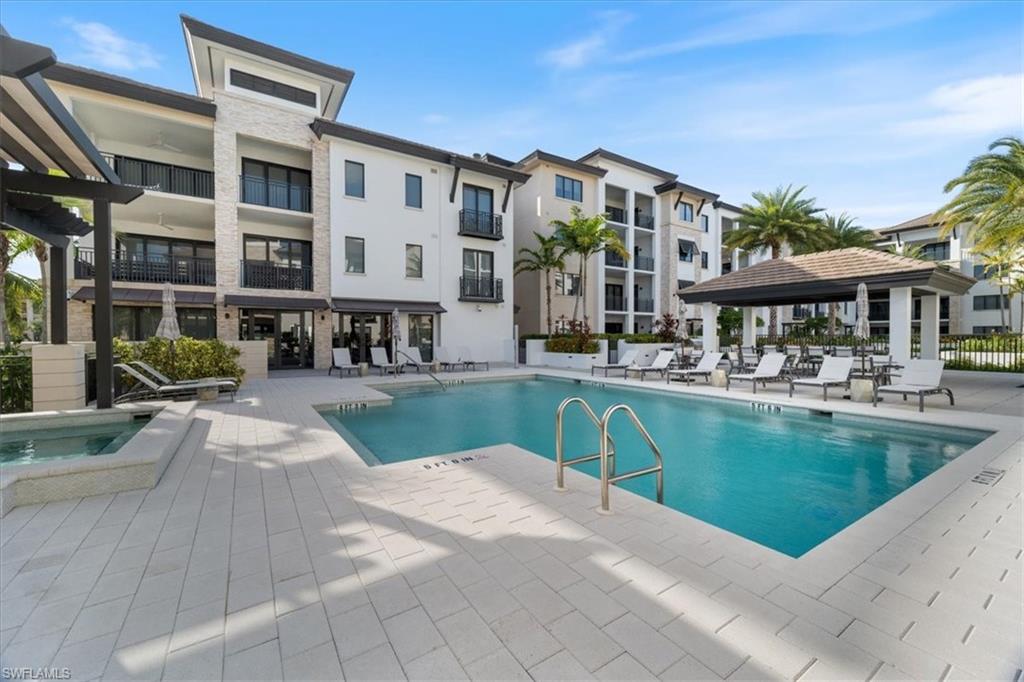 1135 3rd Avenue South, Unit 409 Naples, FL 34102 - Photo 41 of 44 a view of a patio with swimming pool table and chairs