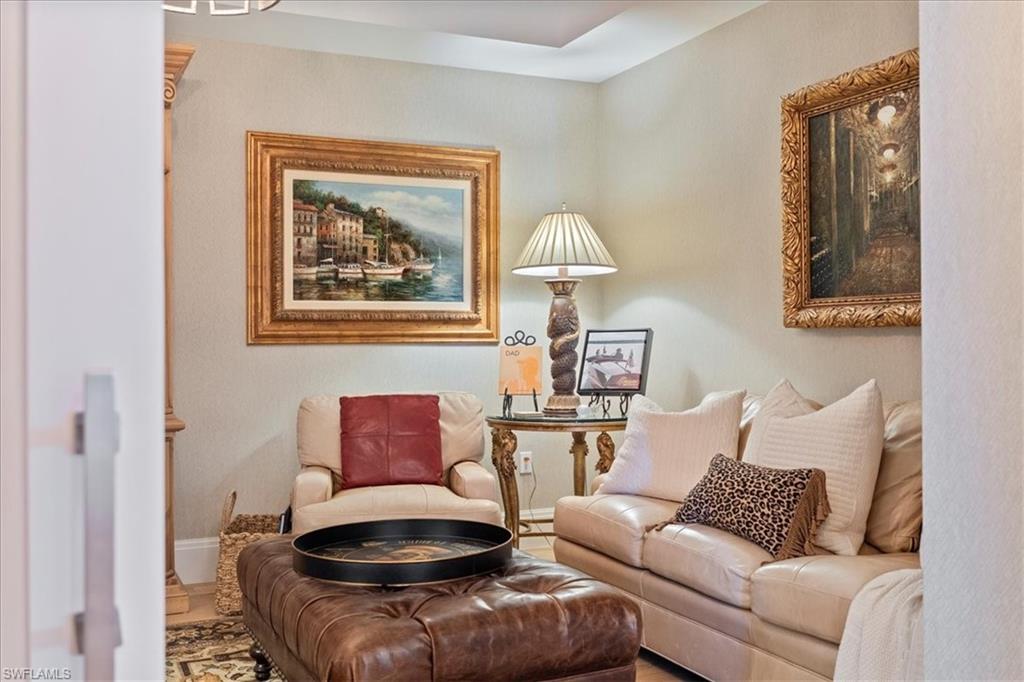 1135 3rd Avenue South, Unit 409 Naples, FL 34102 - Photo 5 of 44 a living room with furniture and a lamp